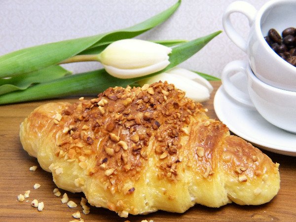Breakfast with coffee tulips and croissant