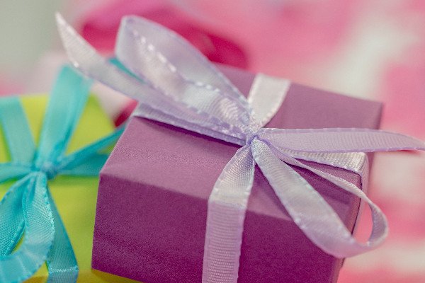 Colorful gift boxes closeup on purple