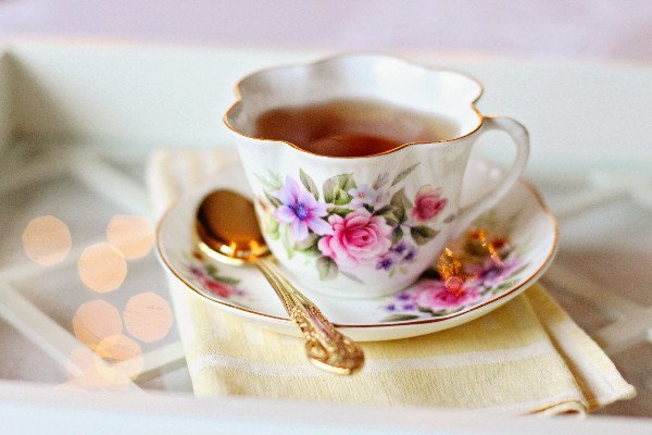 Cup of tea with golden teaspoon