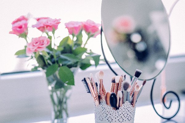 Pink roses makeup brushes and a mirror