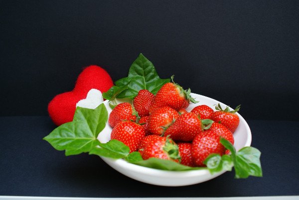 Strawberries and leaves on a dark background